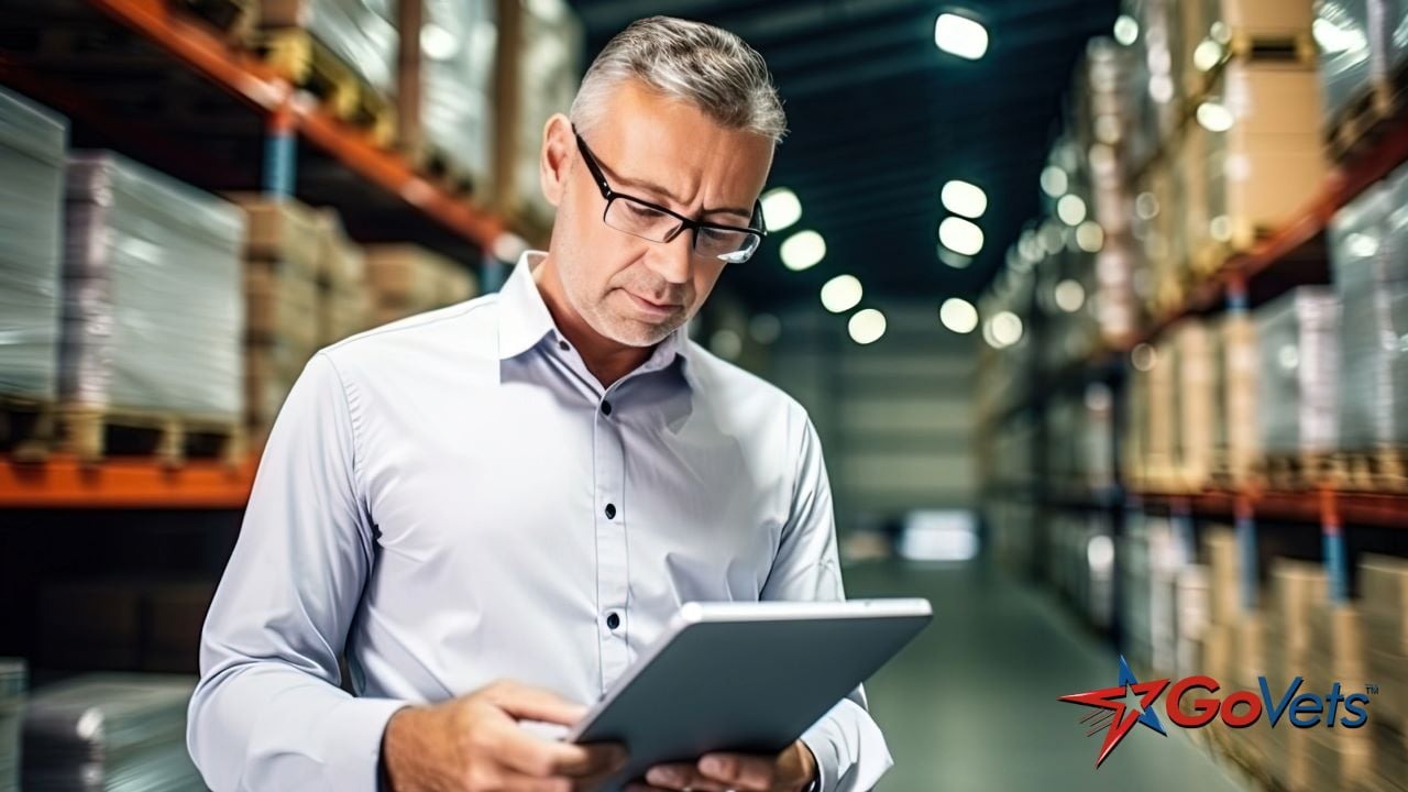 Buying guides - man in warehouse looking at tablet for ecommerce